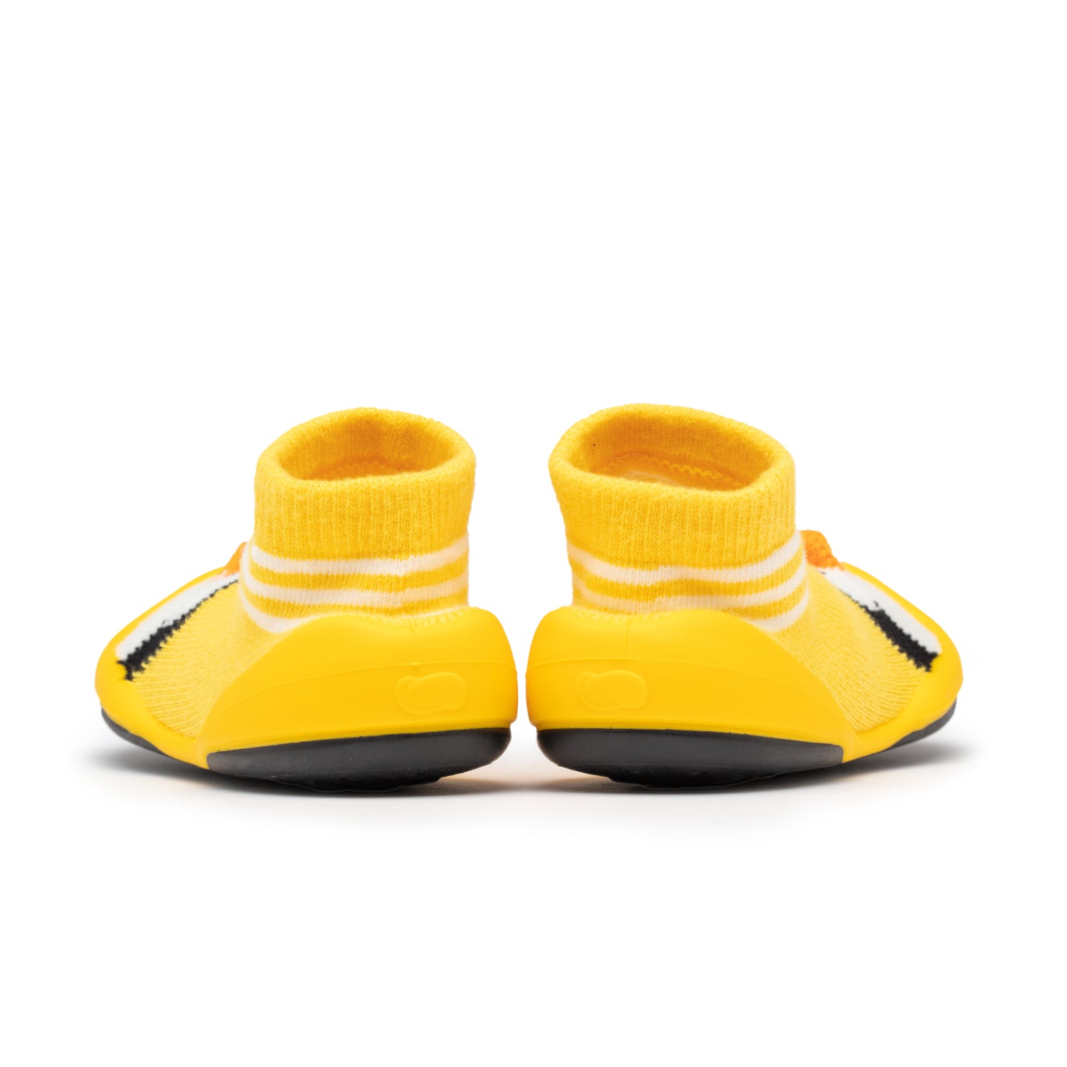 Two yellow baby shoes with white striped socks, viewed from the back, sitting on a white surface.