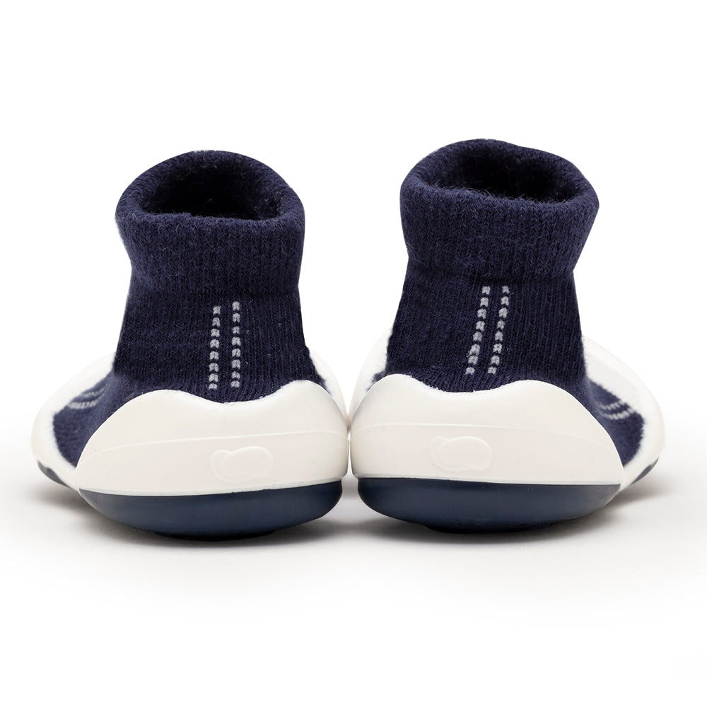 Back view of navy blue and white baby shoes.