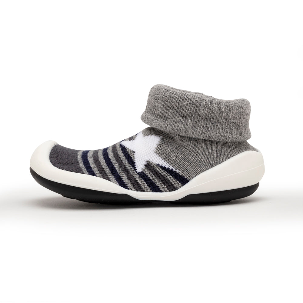 Gray sock shoe with white star and white sole.