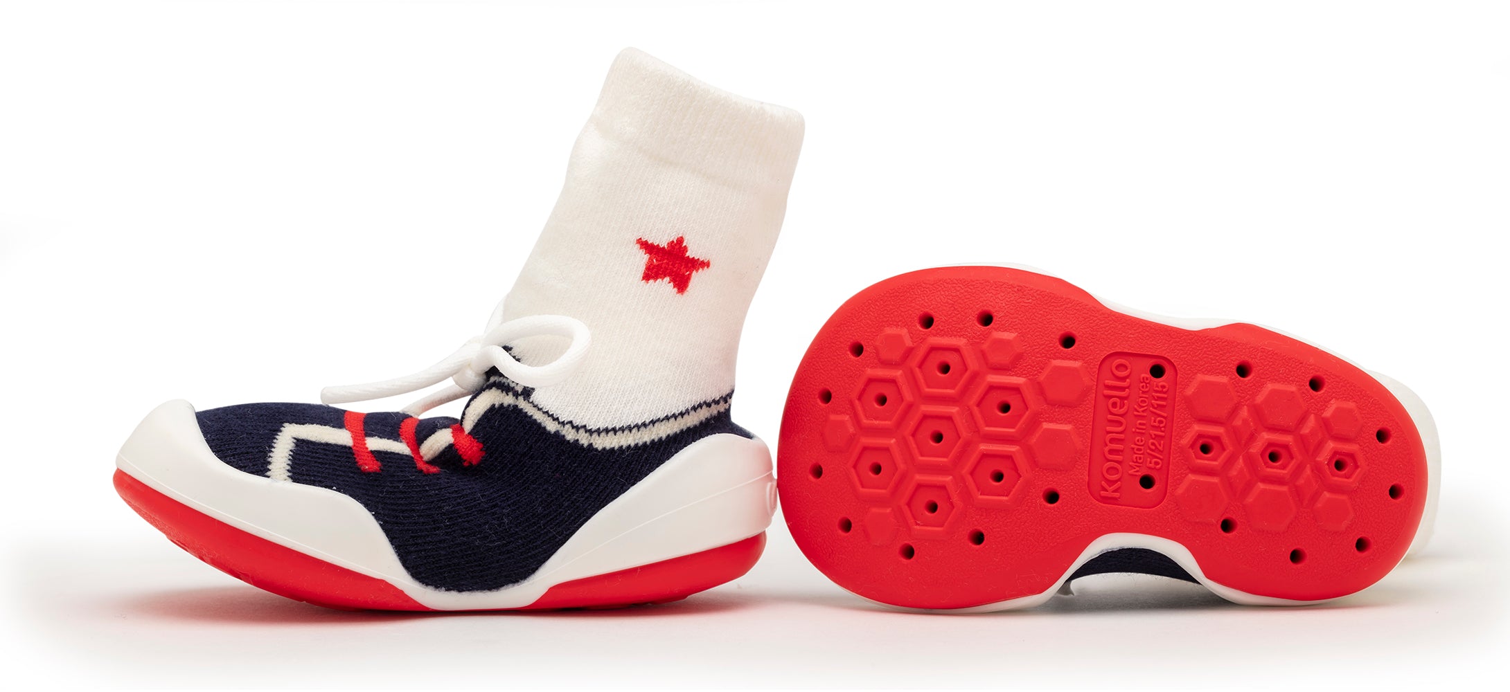 Red and white sock shoes with navy fabric. Sole of shoe features honeycomb pattern.