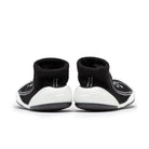 Pair of black and white baby sock shoes.