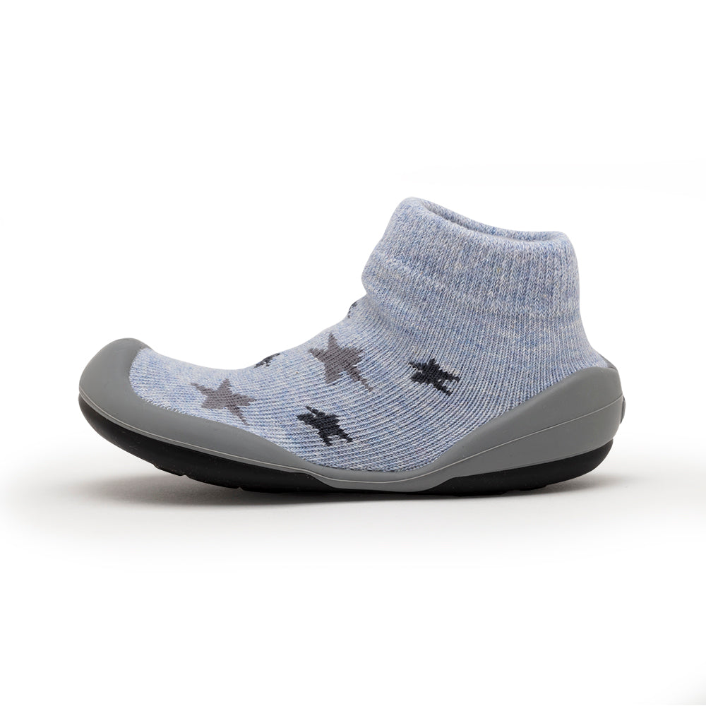 Blue sock-shoe with gray rubber sole and star pattern.