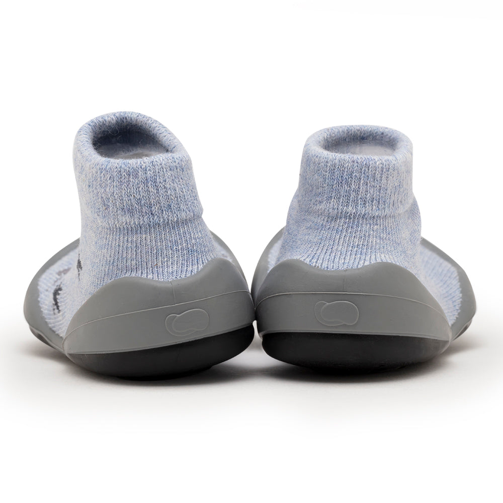 A pair of blue sock shoes with gray soles.
