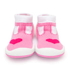 Pair of pink and white baby sock shoes with hearts.