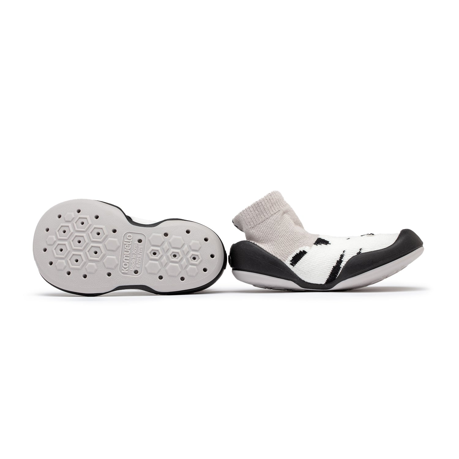 Two baby shoes with sock uppers, one showing the sole.