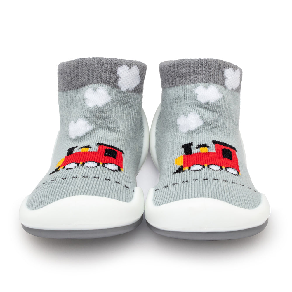 Two gray sock-shoes with train design.