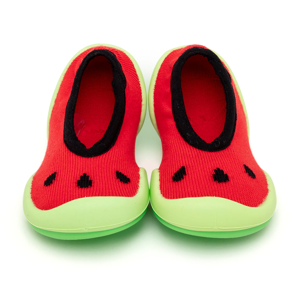 Pair of red, watermelon-themed baby shoes with green soles.