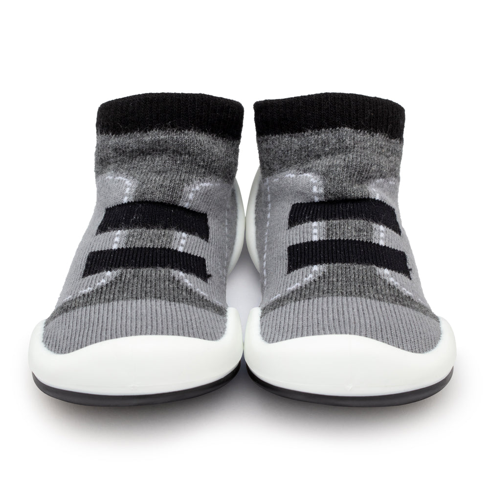 Two gray sock shoes with black stripes and white soles.