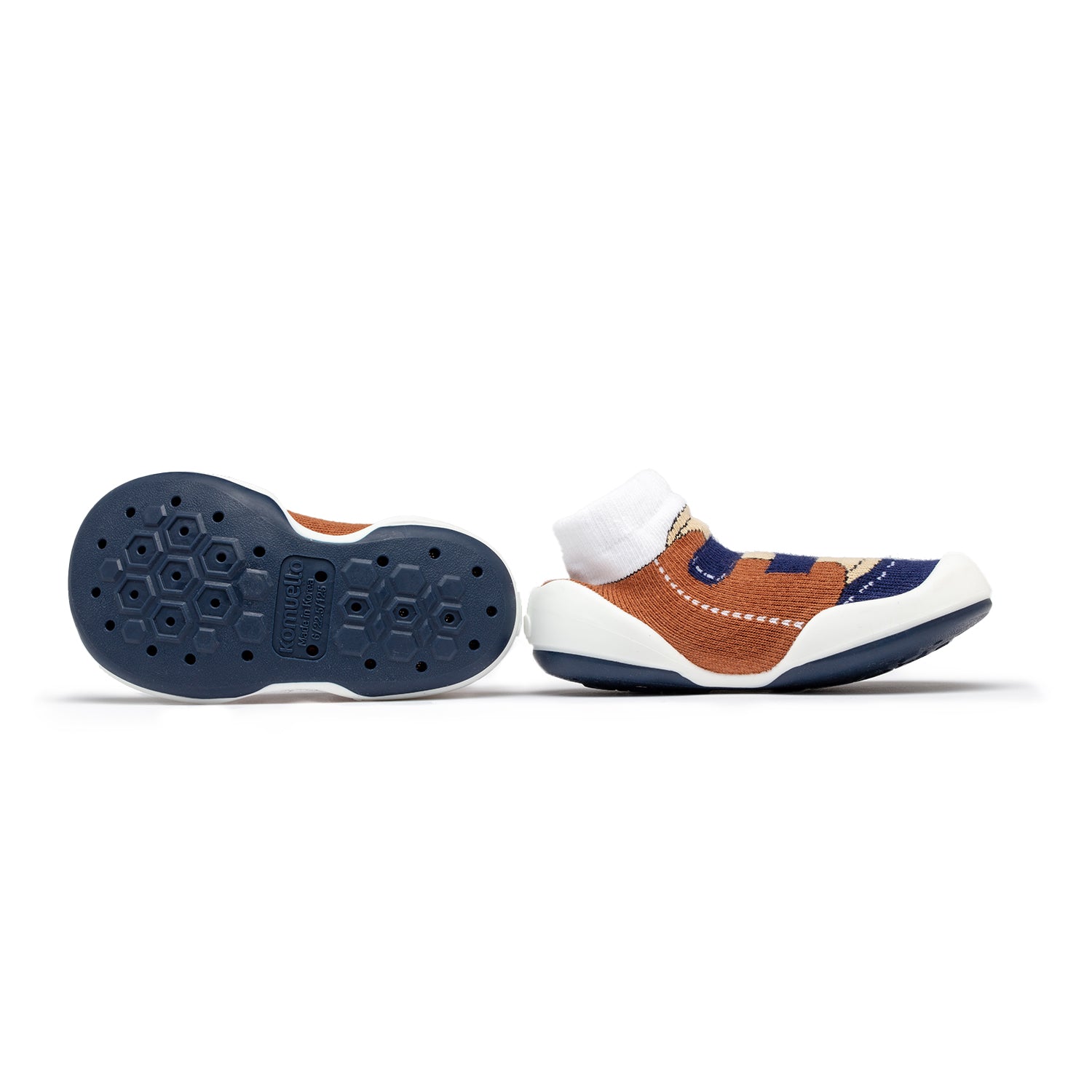 A pair of brown, white, and blue baby sock shoes with geometric design.