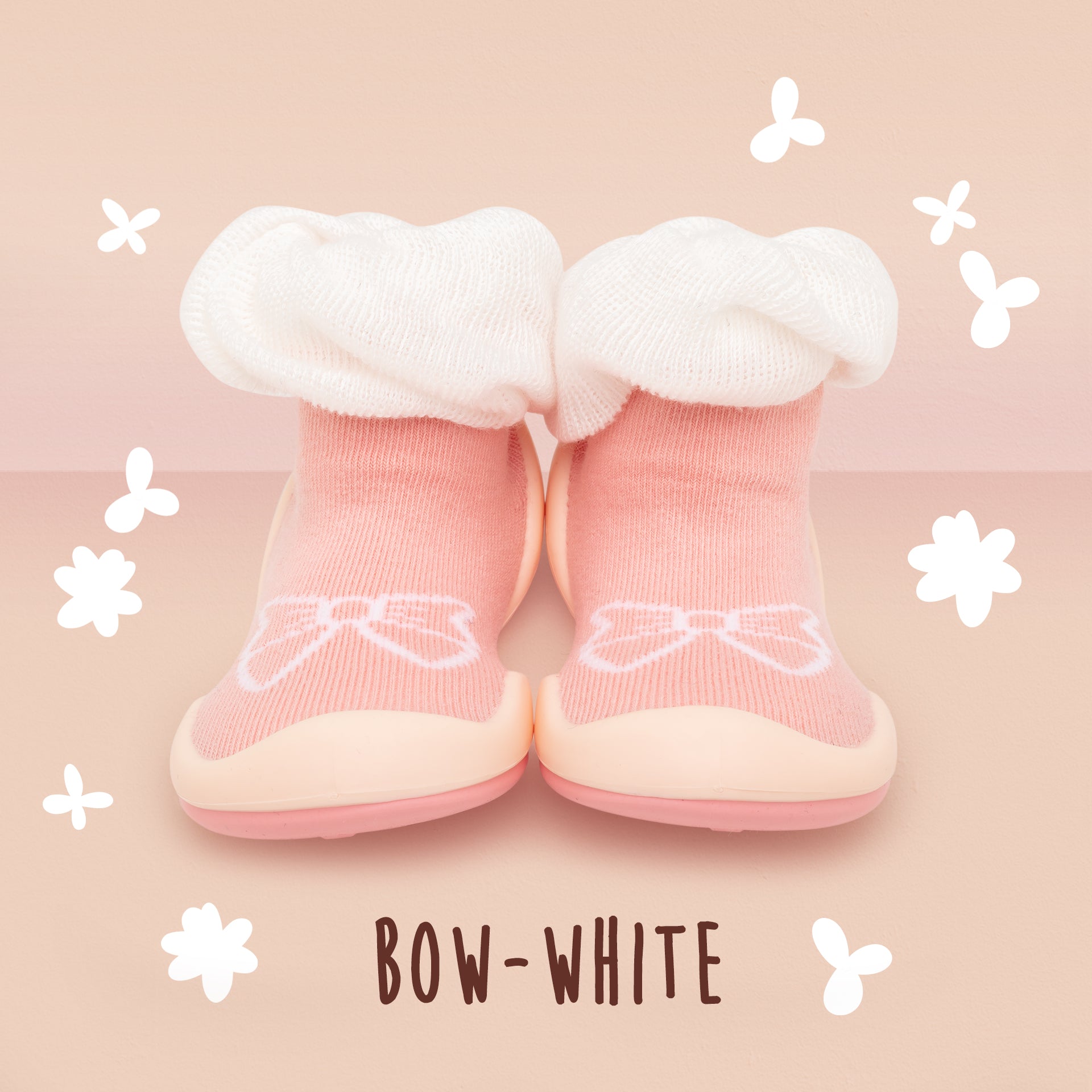Two pink baby booties with white ruffles.