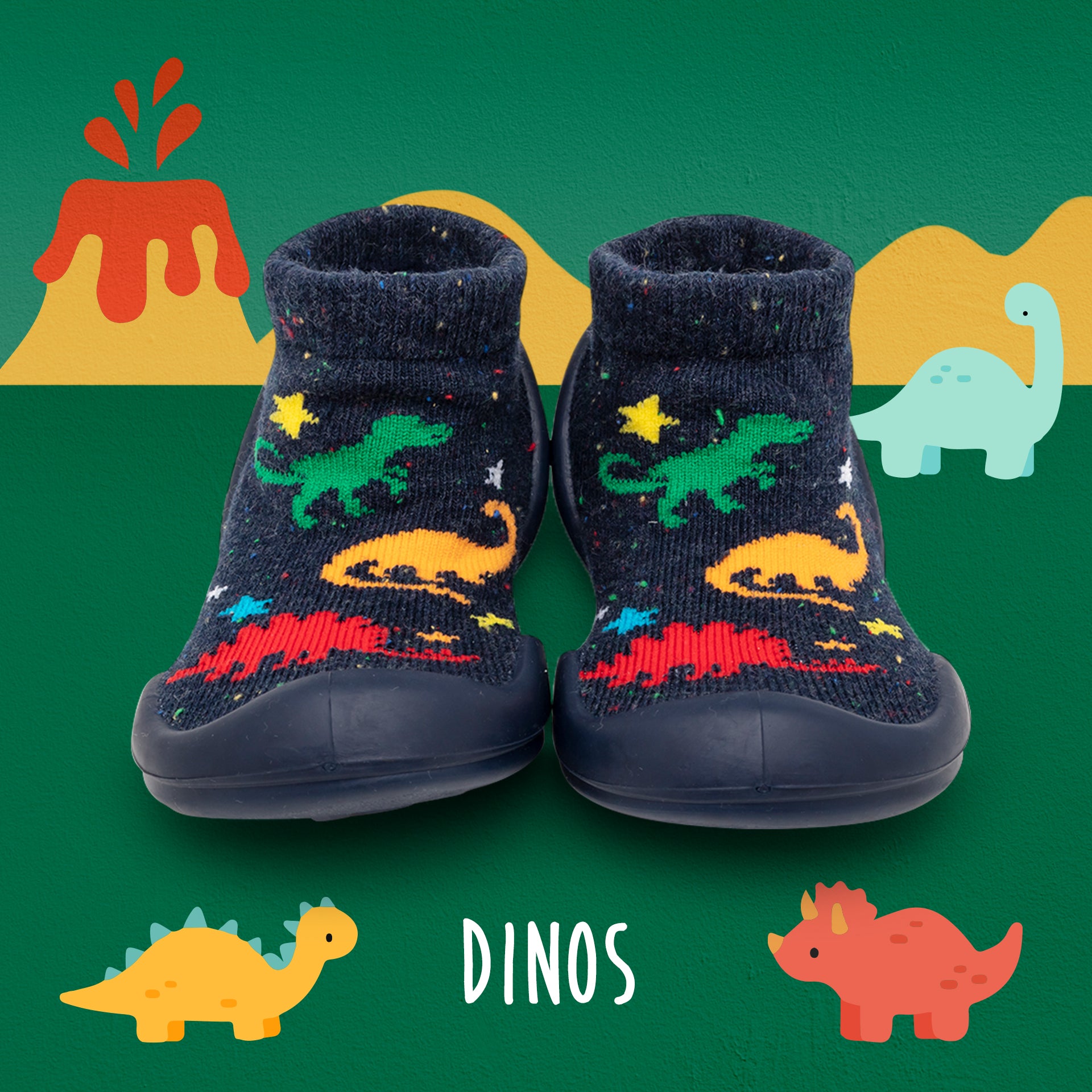 A pair of dinosaur-patterned sock-shoes on a green background with dinosaur illustrations.