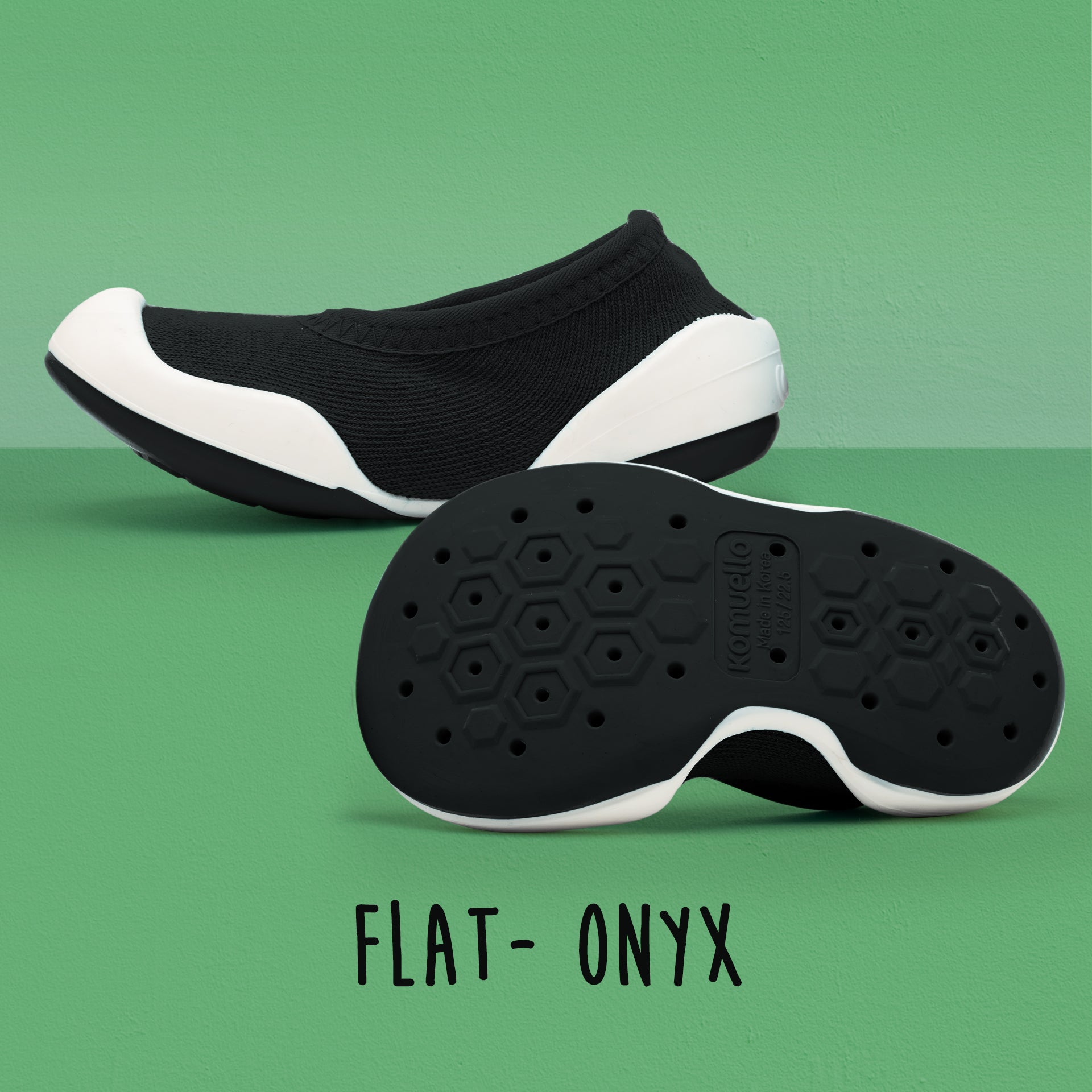 Black and white Komuello shoes with honeycomb-patterned soles.