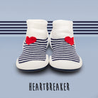 Two baby shoes with white tops, blue stripes, and red hearts.