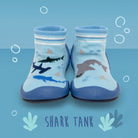 Two blue and white sock-shoes with shark designs.