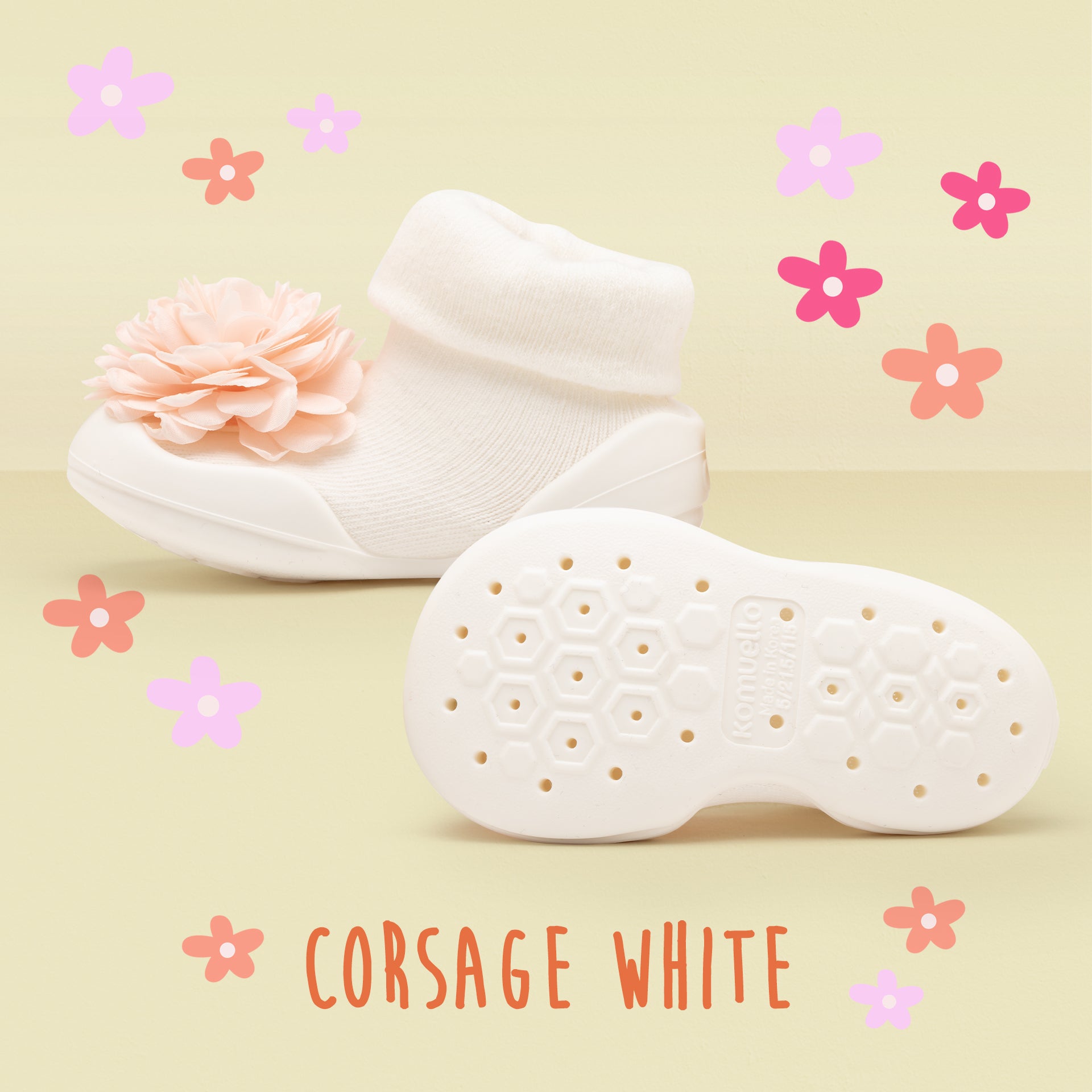 White baby sock shoes with flower embellishment.