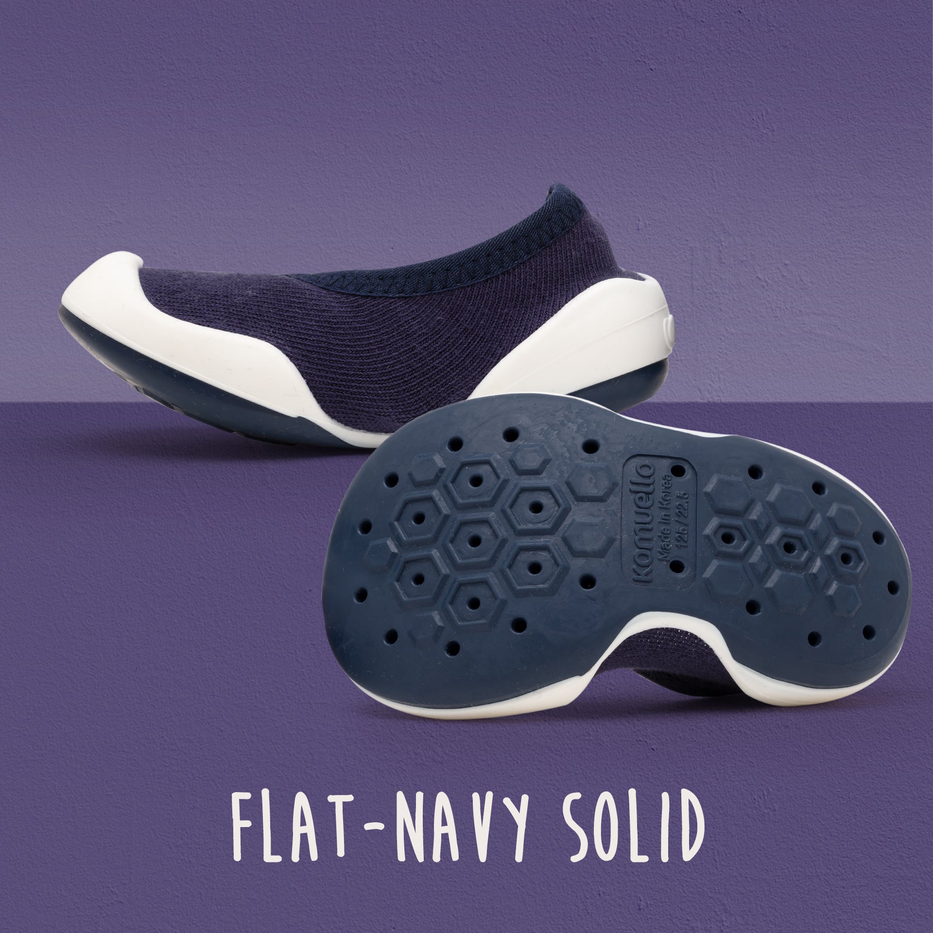 Navy blue and white knit shoe, bottom view of sole.