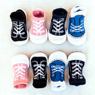 Eight baby sock shoes with laces.
