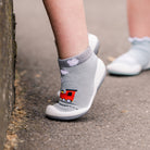 Child's sock shoes with train design.