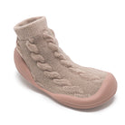 Beige sock-slipper with cable knit and rubber sole.
