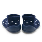 Two navy blue baby slippers with white flower patterns.