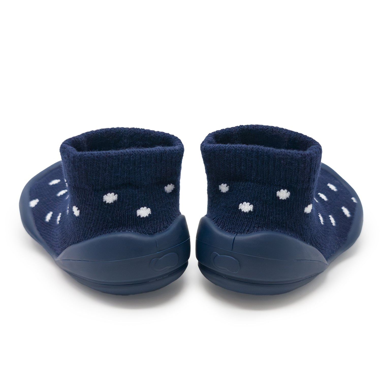 Two navy blue baby slippers with white flower patterns.