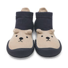 Two baby sock shoes with dark blue sock tops, tan bear faces, and dark blue rubber soles.