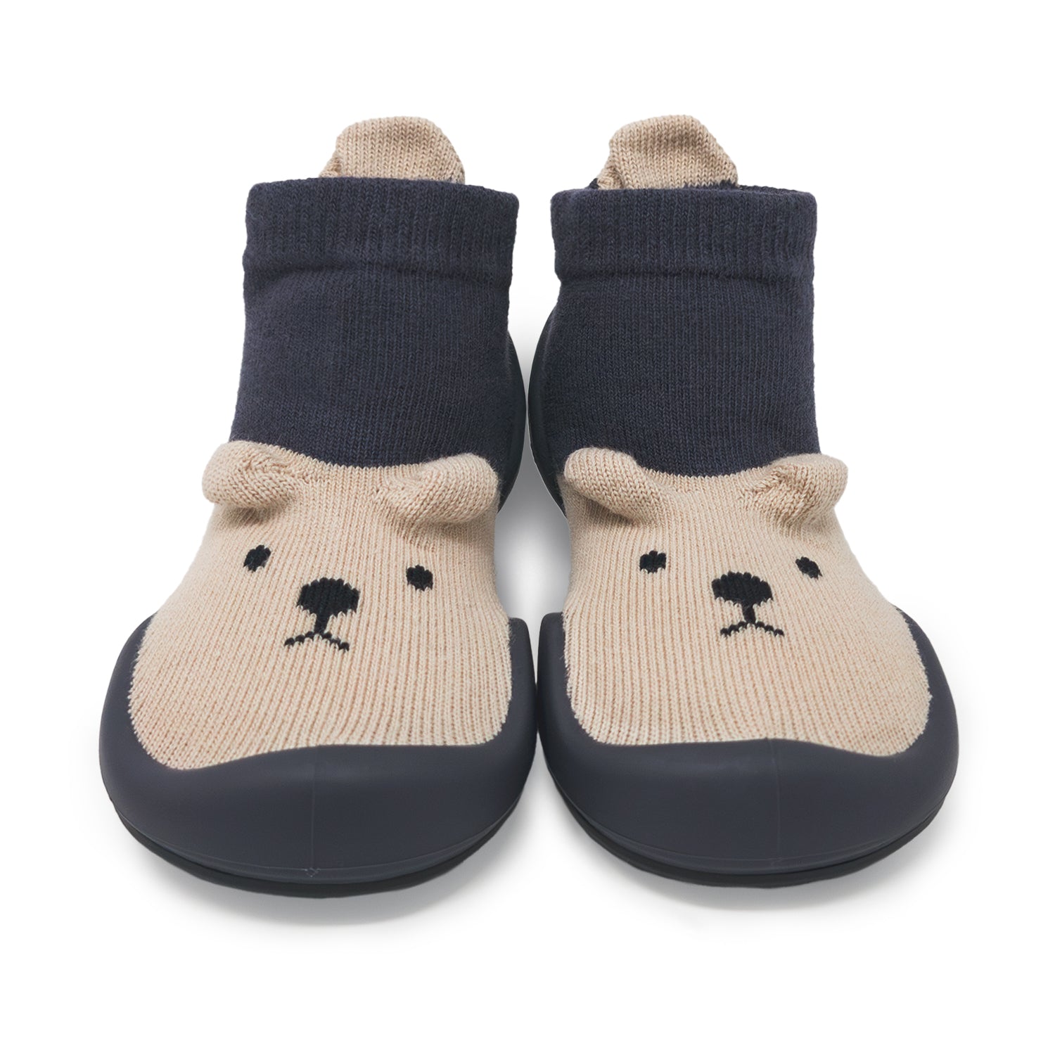 Two baby sock shoes with dark blue sock tops, tan bear faces, and dark blue rubber soles.