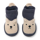 A pair of knitted baby shoes with bear designs.