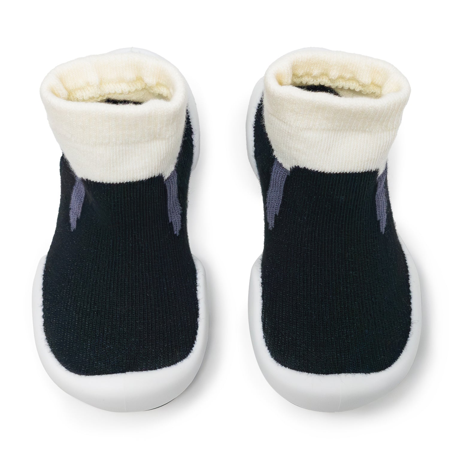 Two black baby slipper socks with white cuffs and soles.