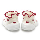 Two white baby booties with red hearts and red ruffled trim.